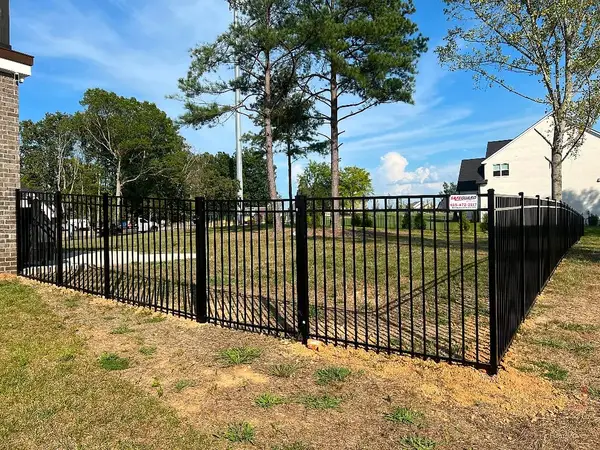 Black aluminum fence around a backyard with a SafeGuard sign