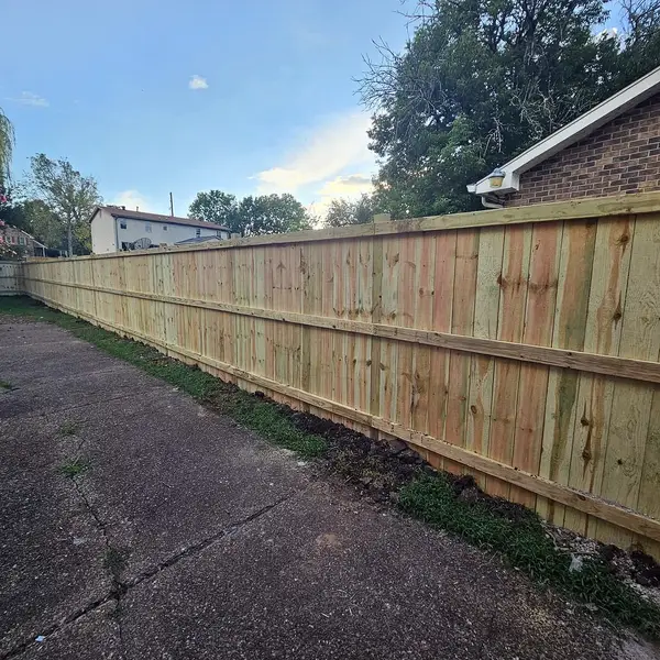 Pine privacy fence running down a driveway