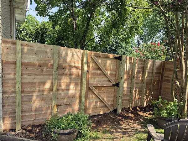 Horizontal wood fence with a walk gate
