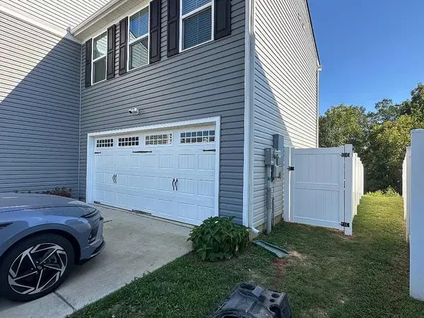 White vinyl fence beside a two-story home