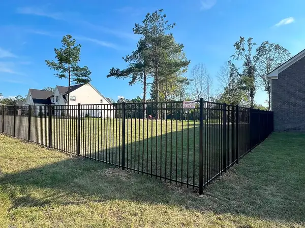 Black aluminum fence along a backyard